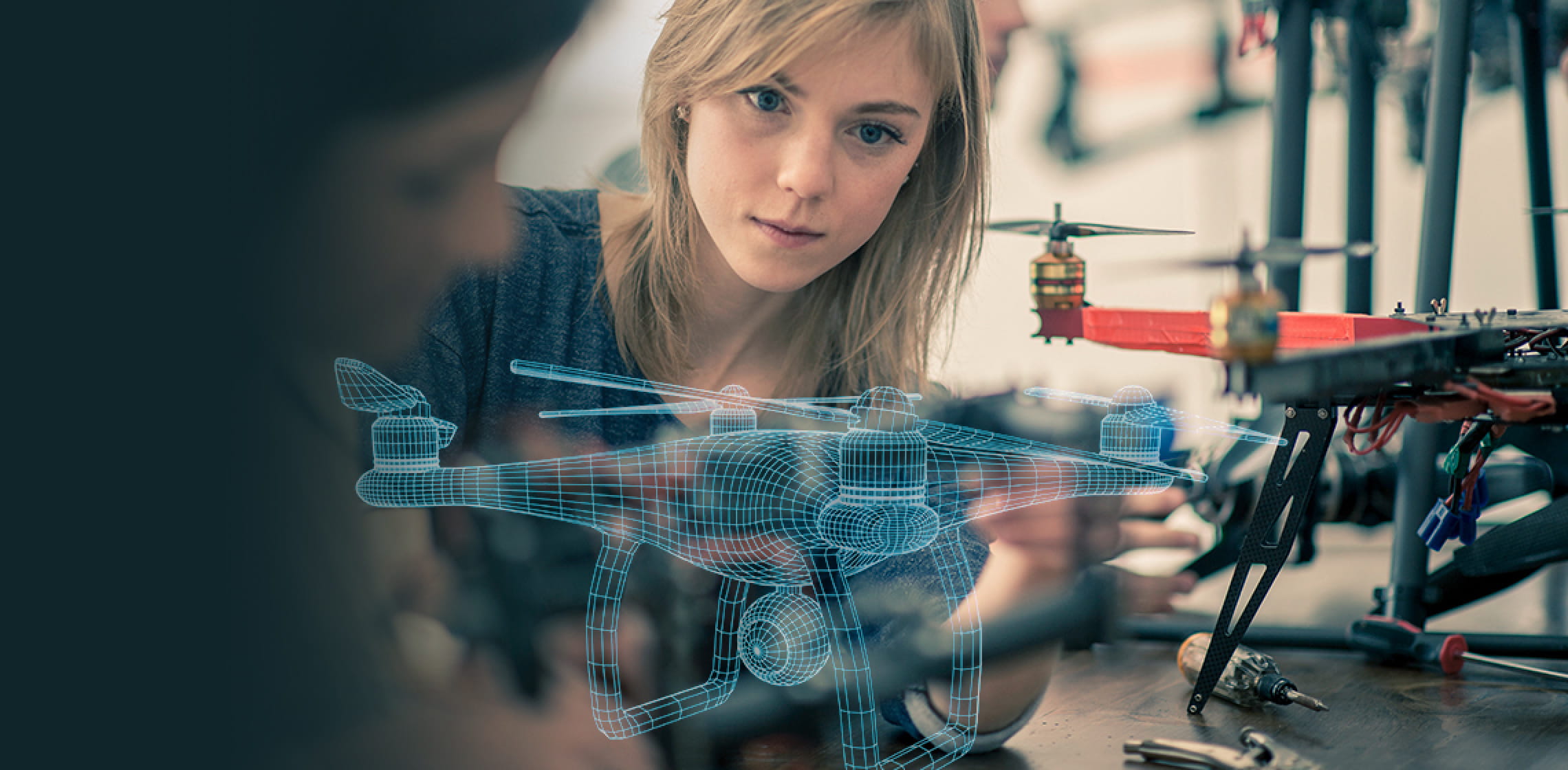 Female student is watching on semi transparent lines that shows final look of drone.